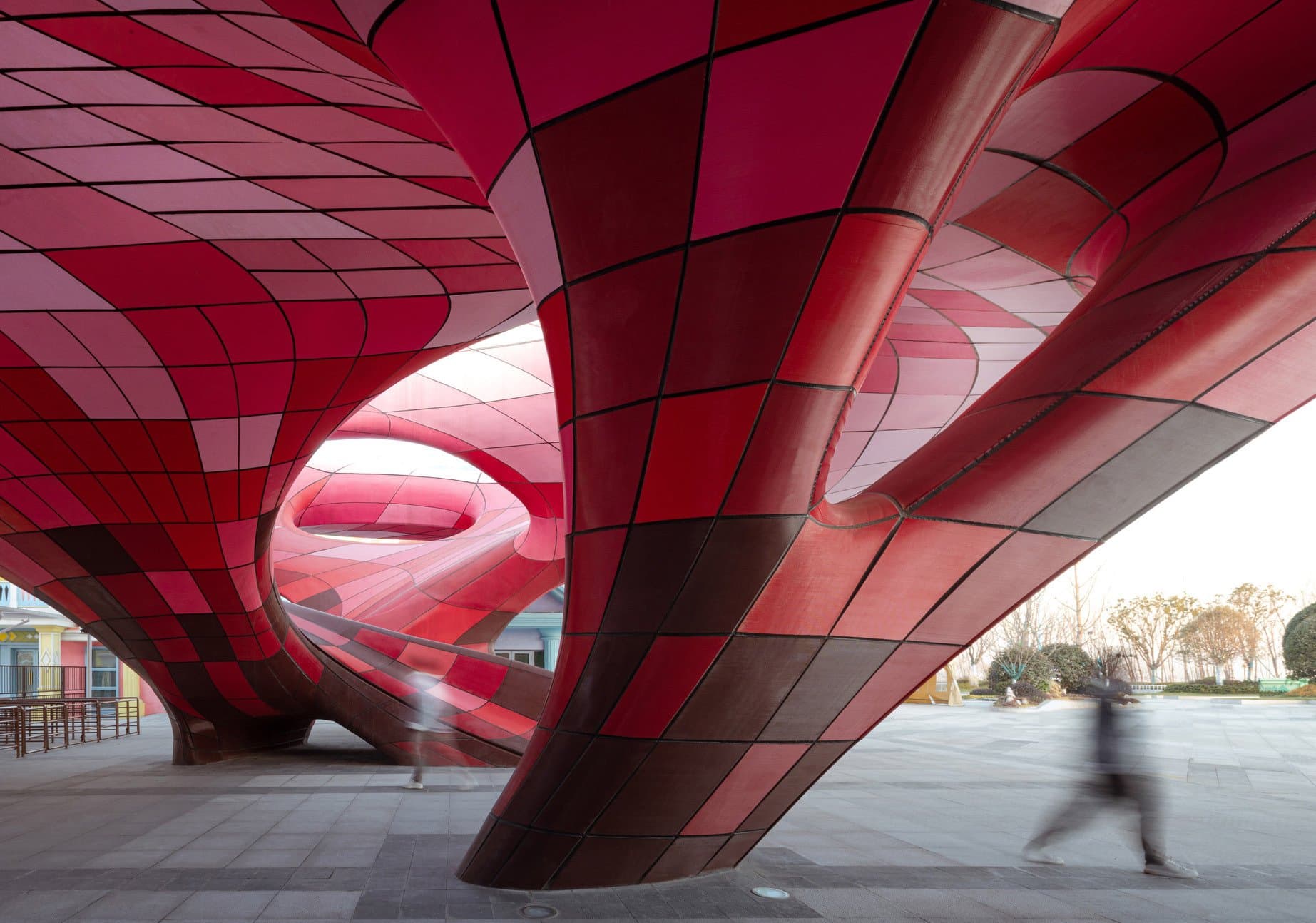 Inside the completed Happy Valley East Gate — red 3D printed panels over the plaza