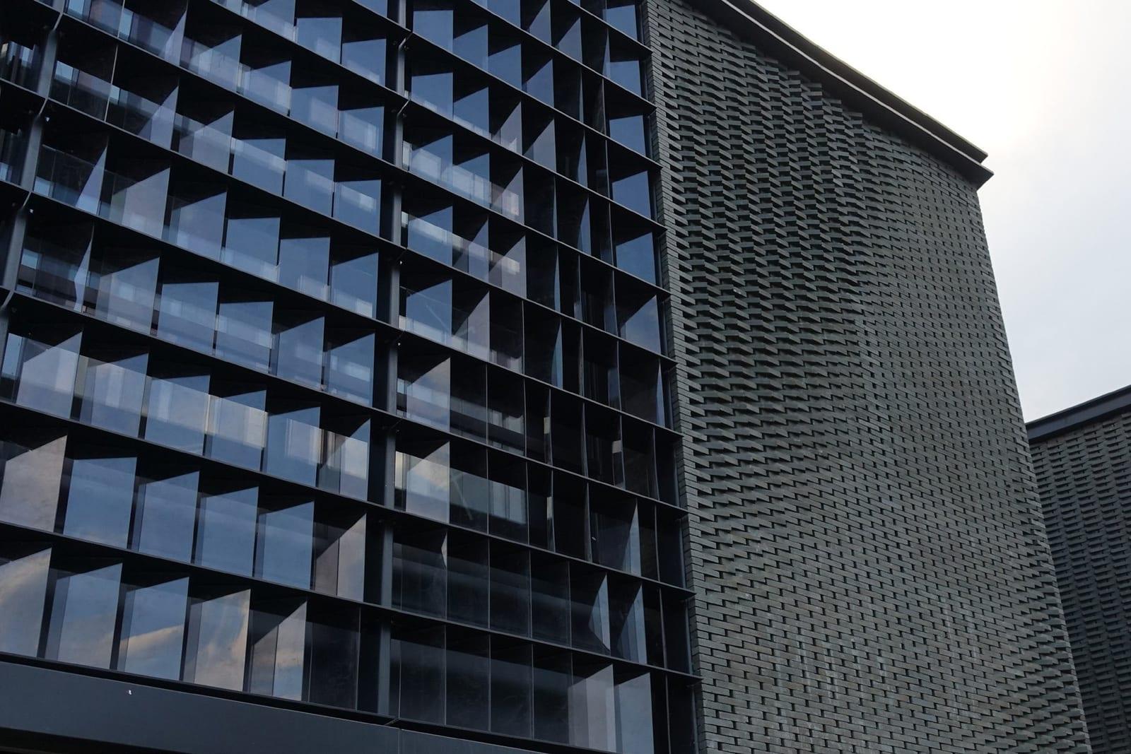 Built facade at Panlong Tiandi with dark brick and glass louvers