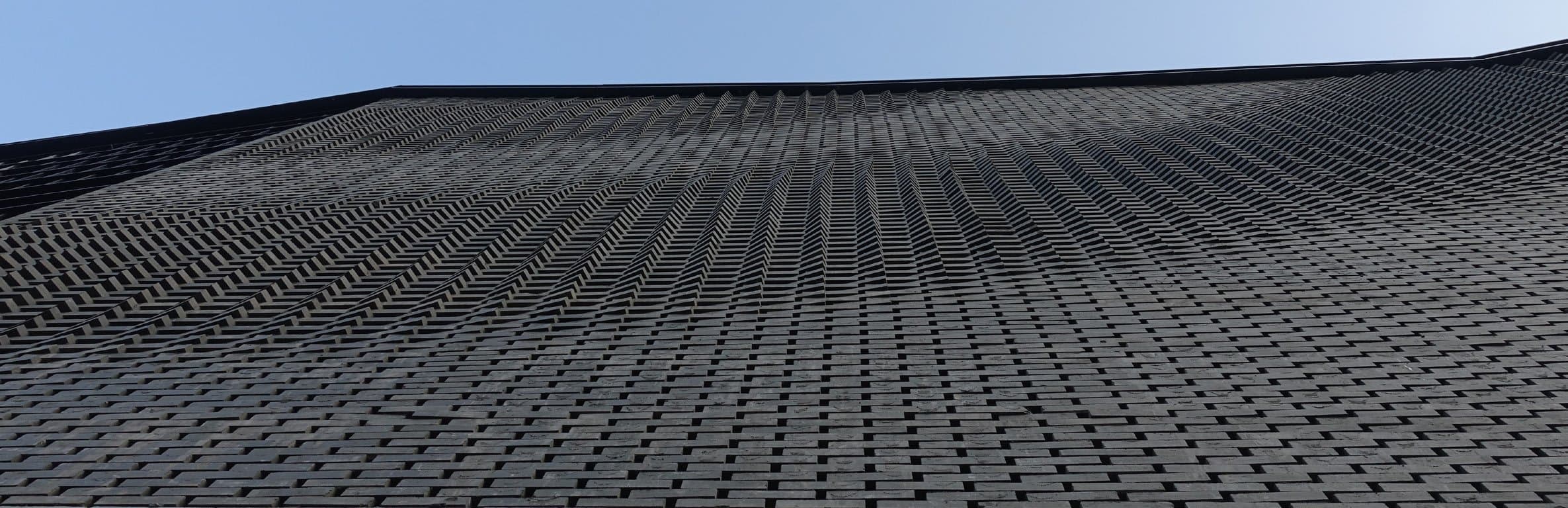 Continuous louver and brick pattern across the elevation