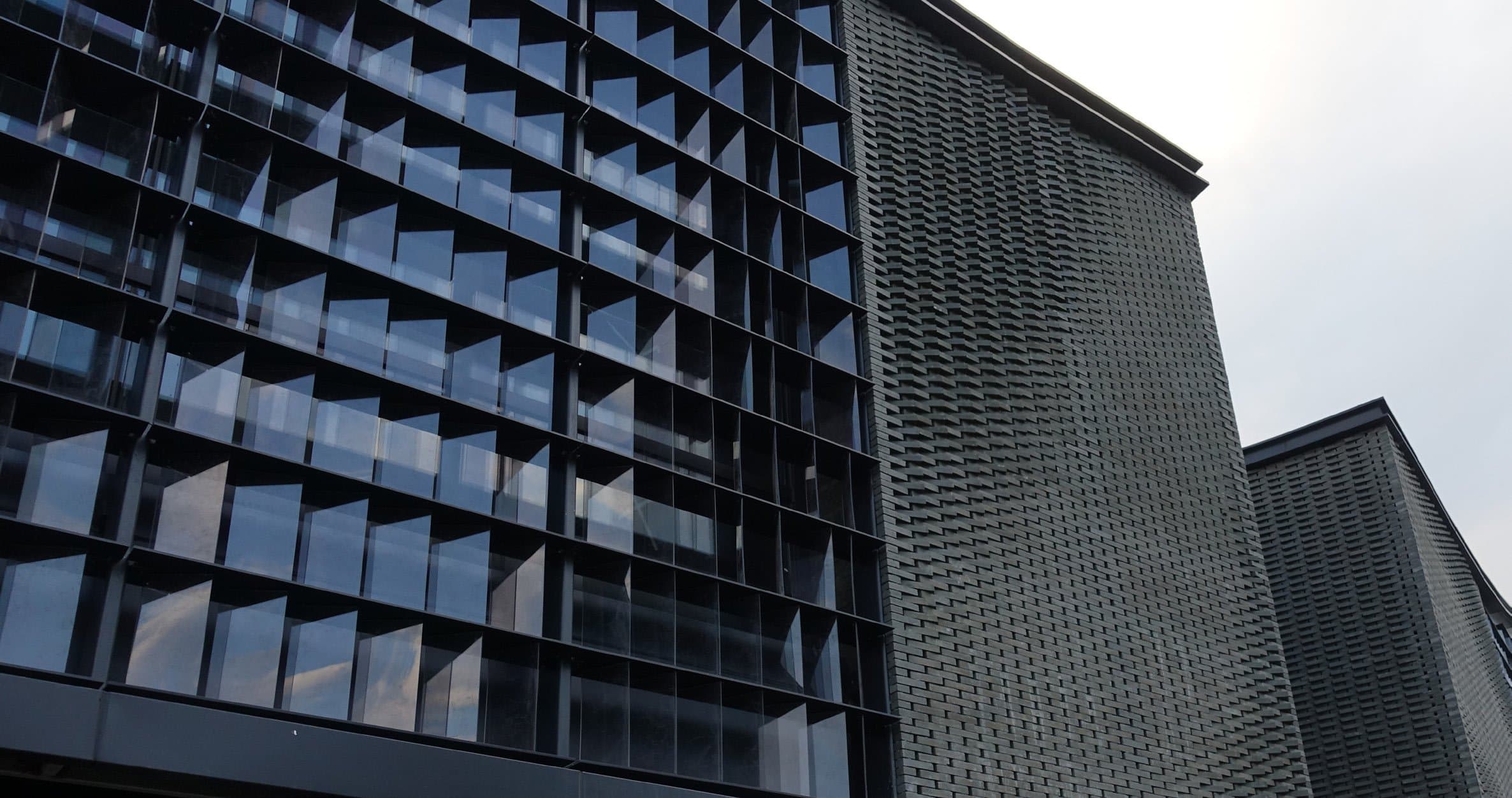 Built facade at Panlong Tiandi with dark brick and glass louvers