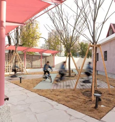Renovated public space with pink steel canopy and seating