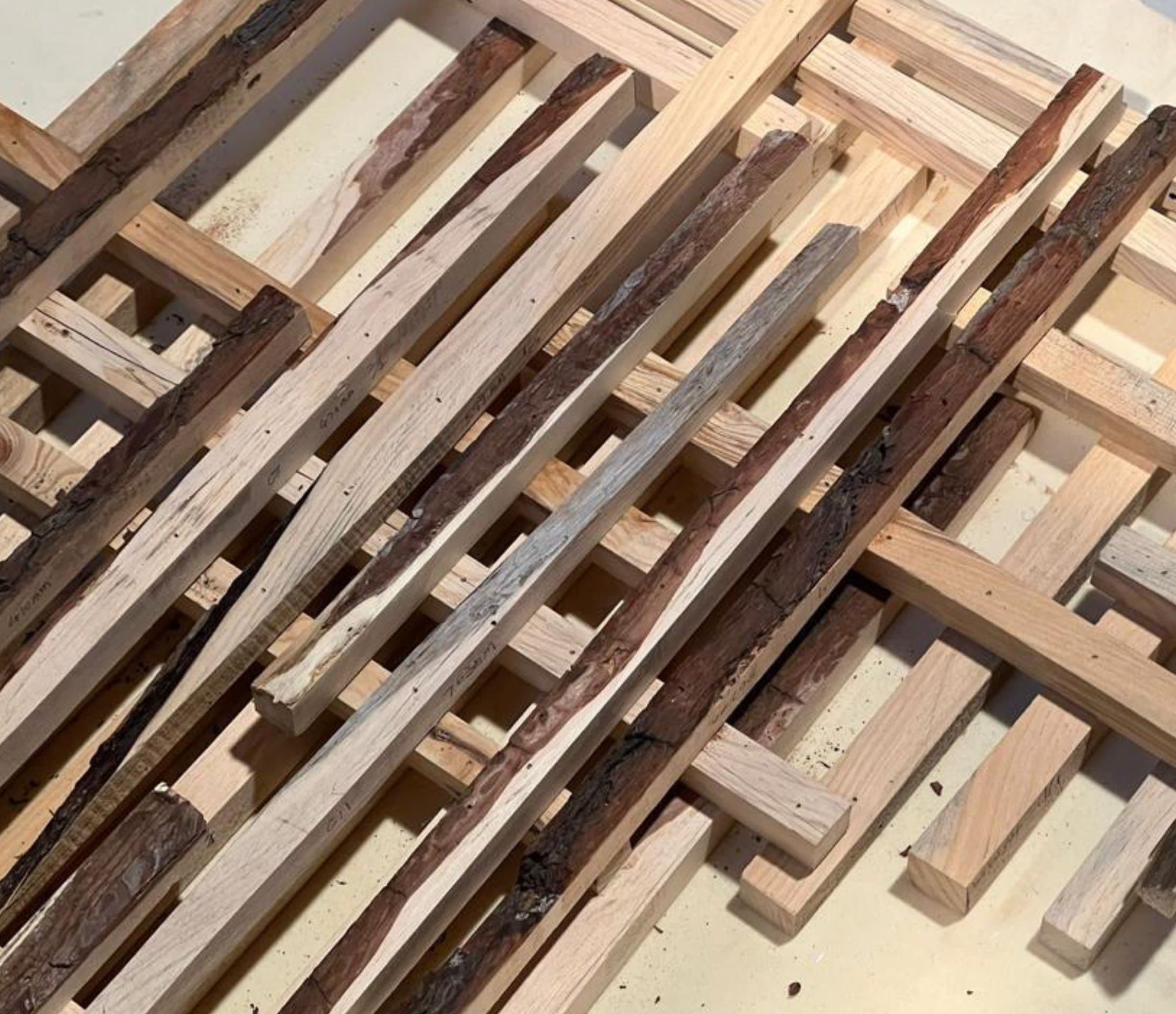 Robotic assembly of wood offcut sticks for the facade system