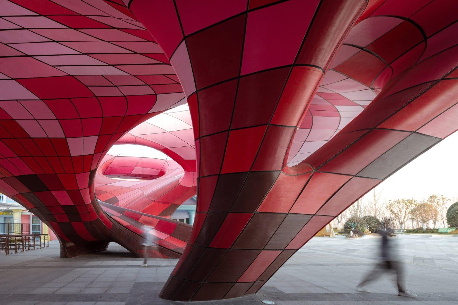 Inside the completed Happy Valley East Gate — red 3D printed panels over the plaza