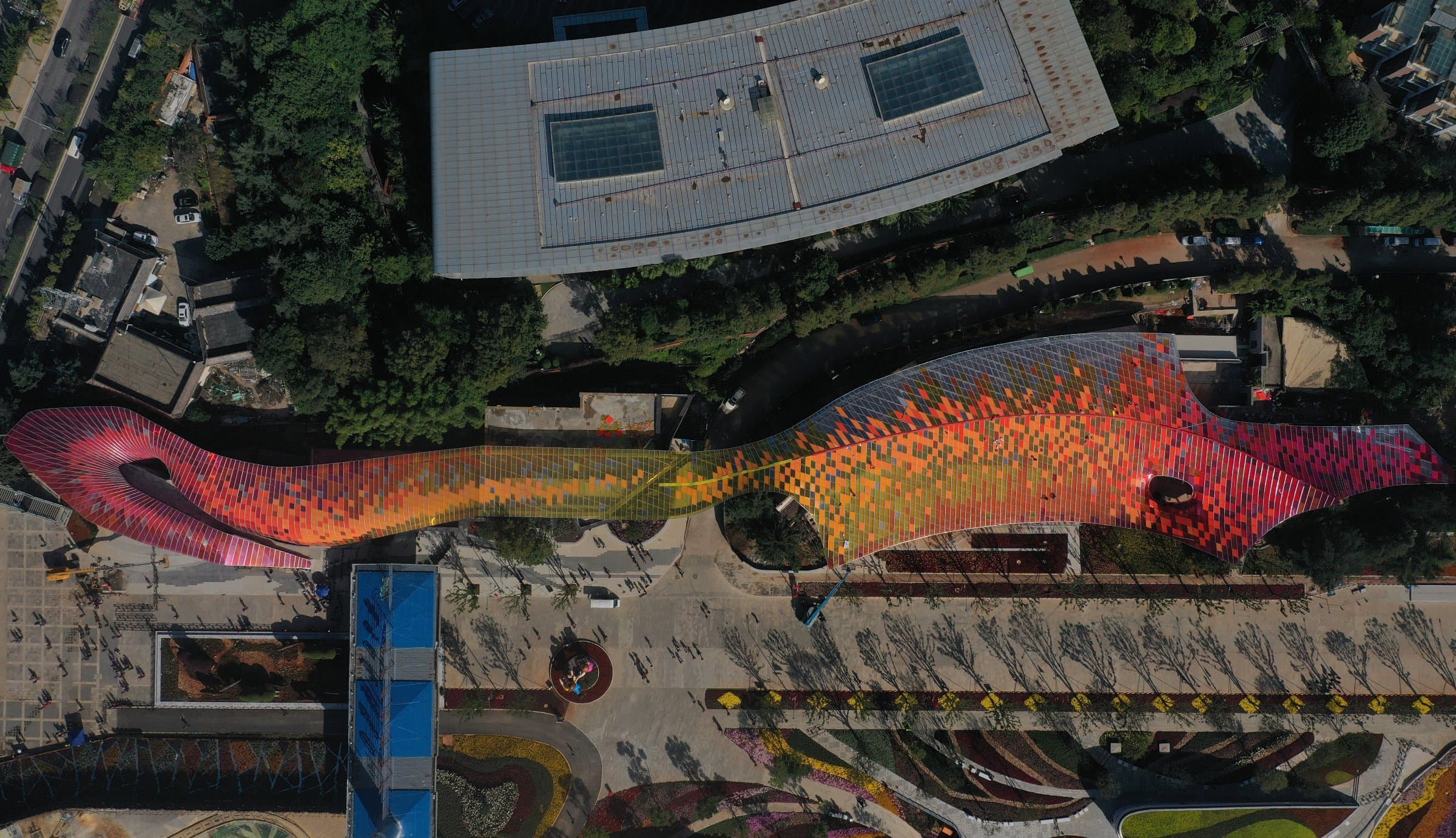 Aerial view of the colourful pixelated canopy winding through Kunming Expo Park