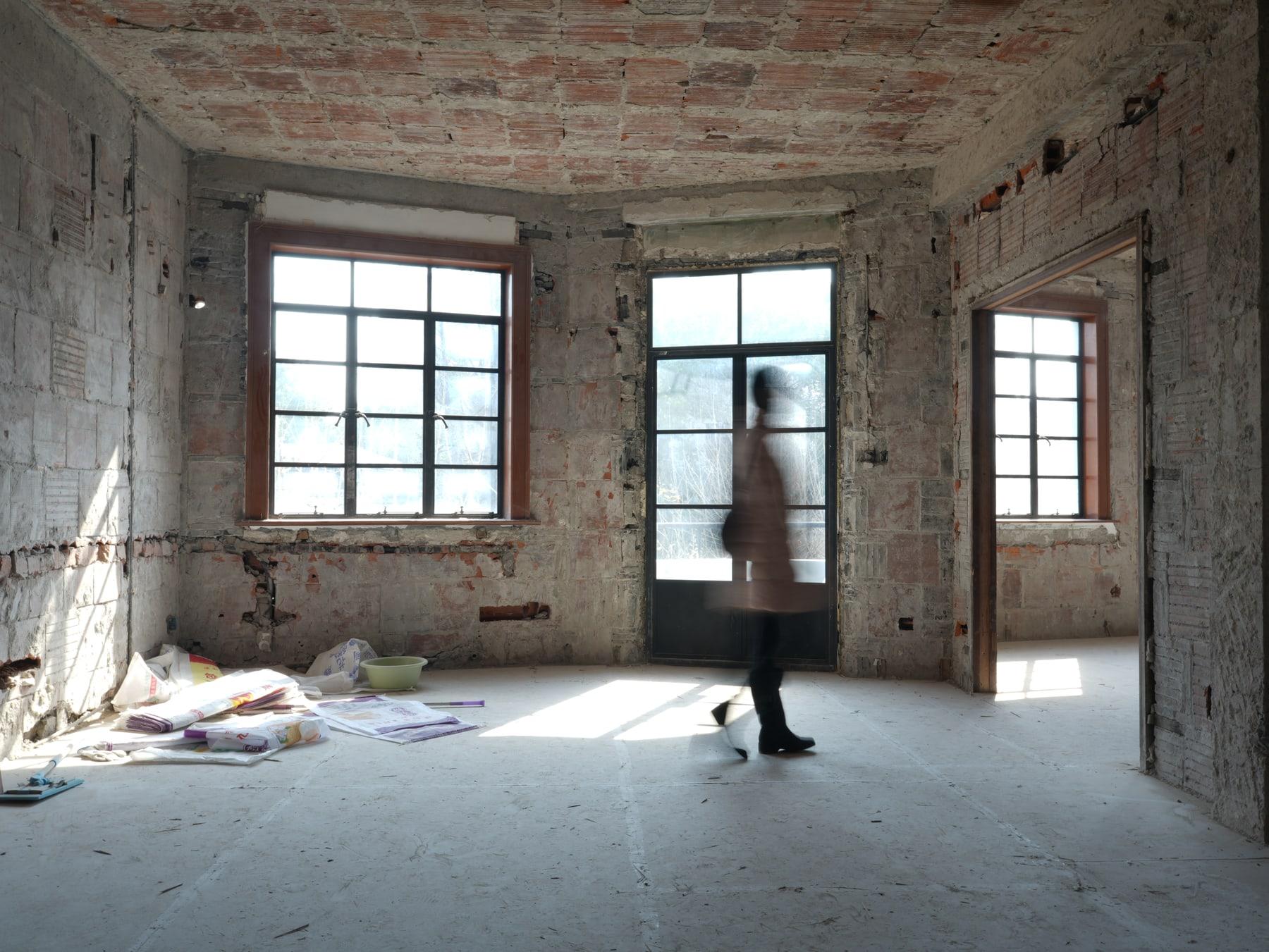 Figure walking through the vaulted brick room