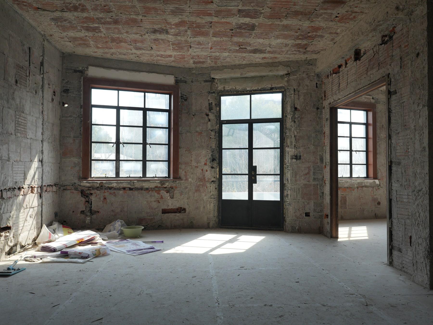 The empty vaulted room with three steel-frame windows
