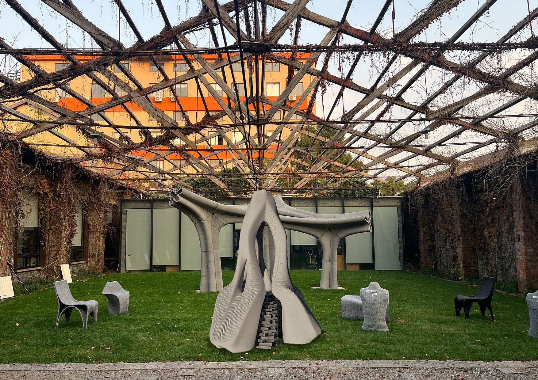 The printed pavilion glowing under the orange-lit woven canopy at dusk