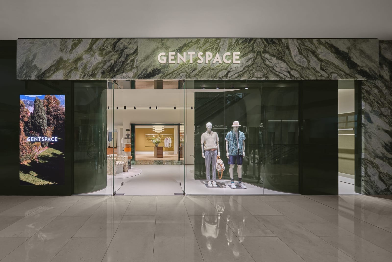 The GENTSPACE storefront — green book-matched marble fascia with illuminated sign