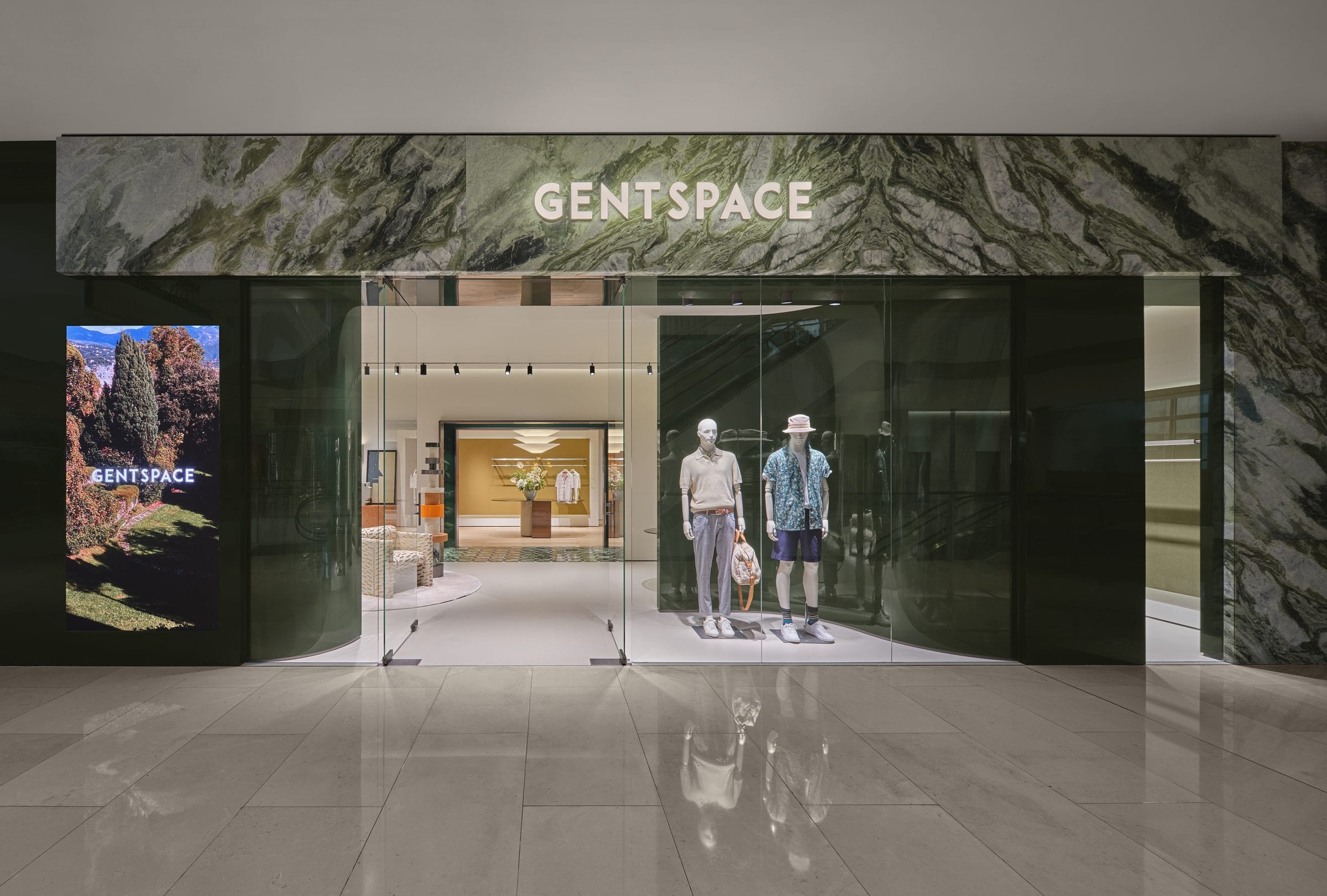 The GENTSPACE storefront — green book-matched marble fascia with illuminated sign