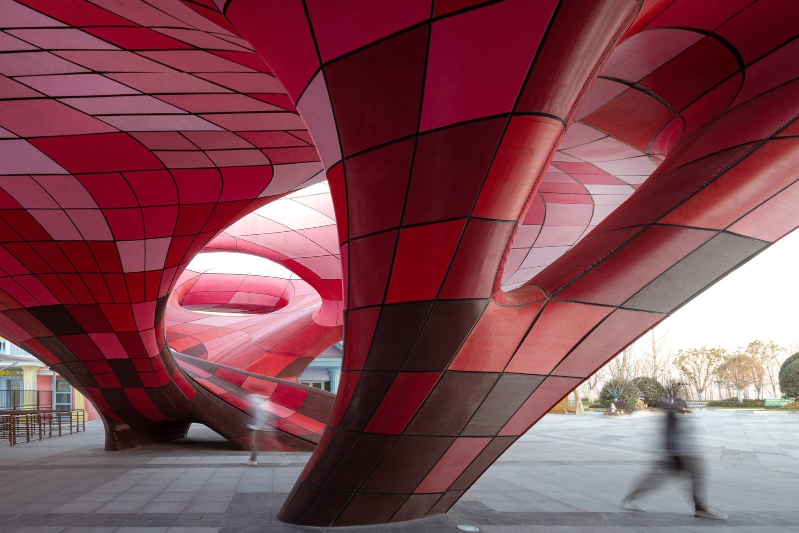 Inside the completed Happy Valley East Gate — red 3D printed panels over the plaza