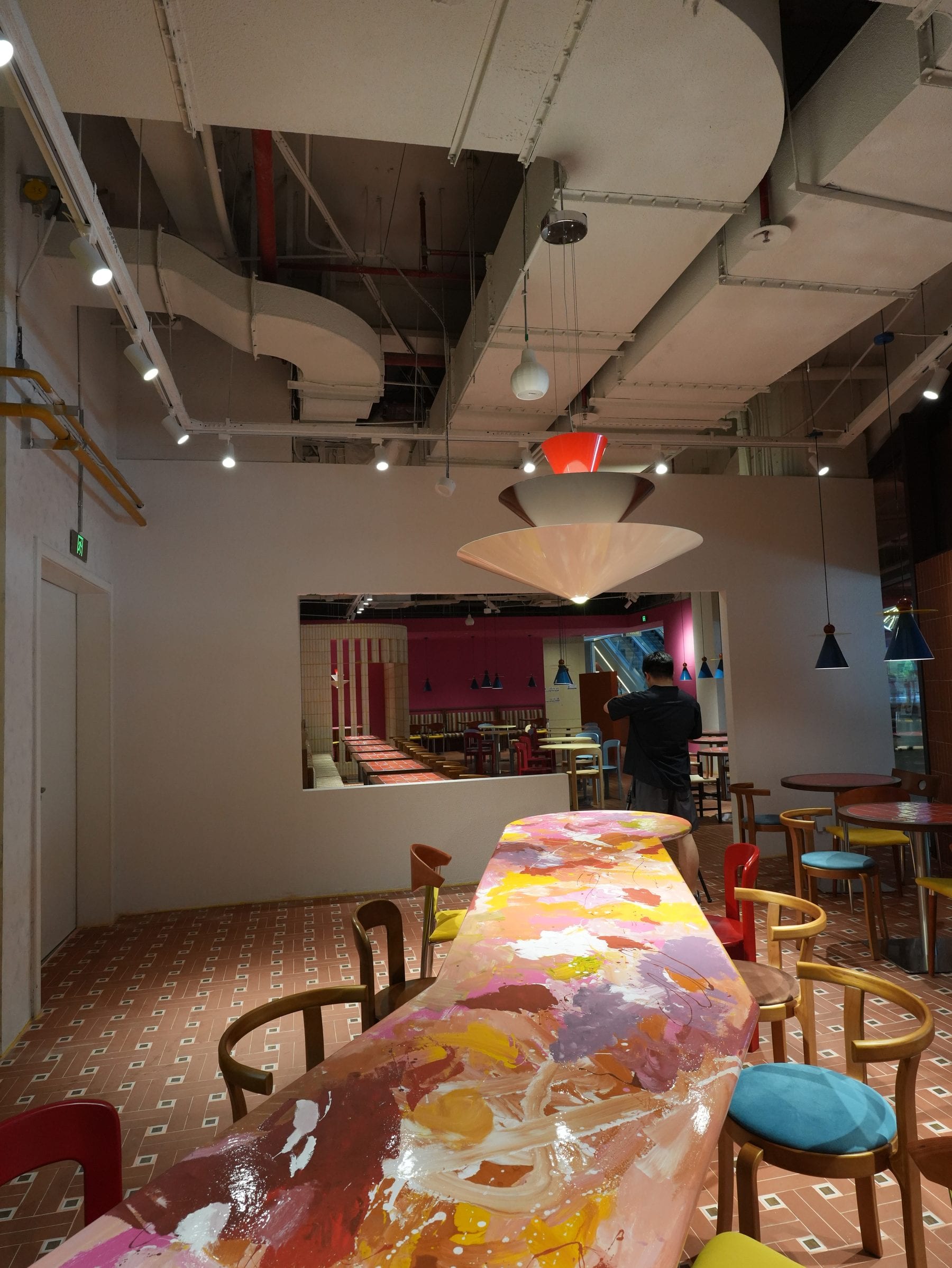 Communal table cast in swirling multicoloured resin