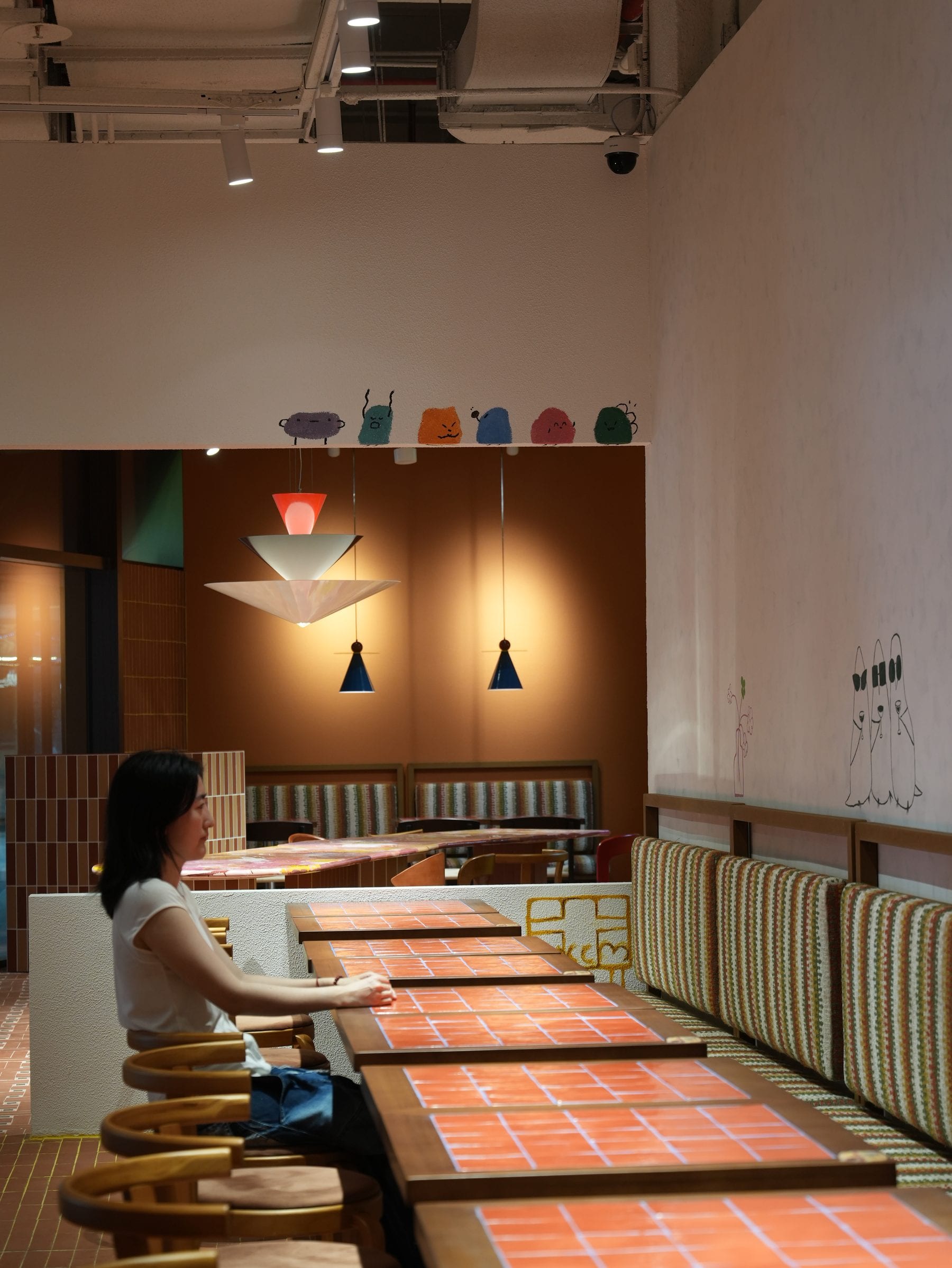 Banquette wall with sculptural white lamp