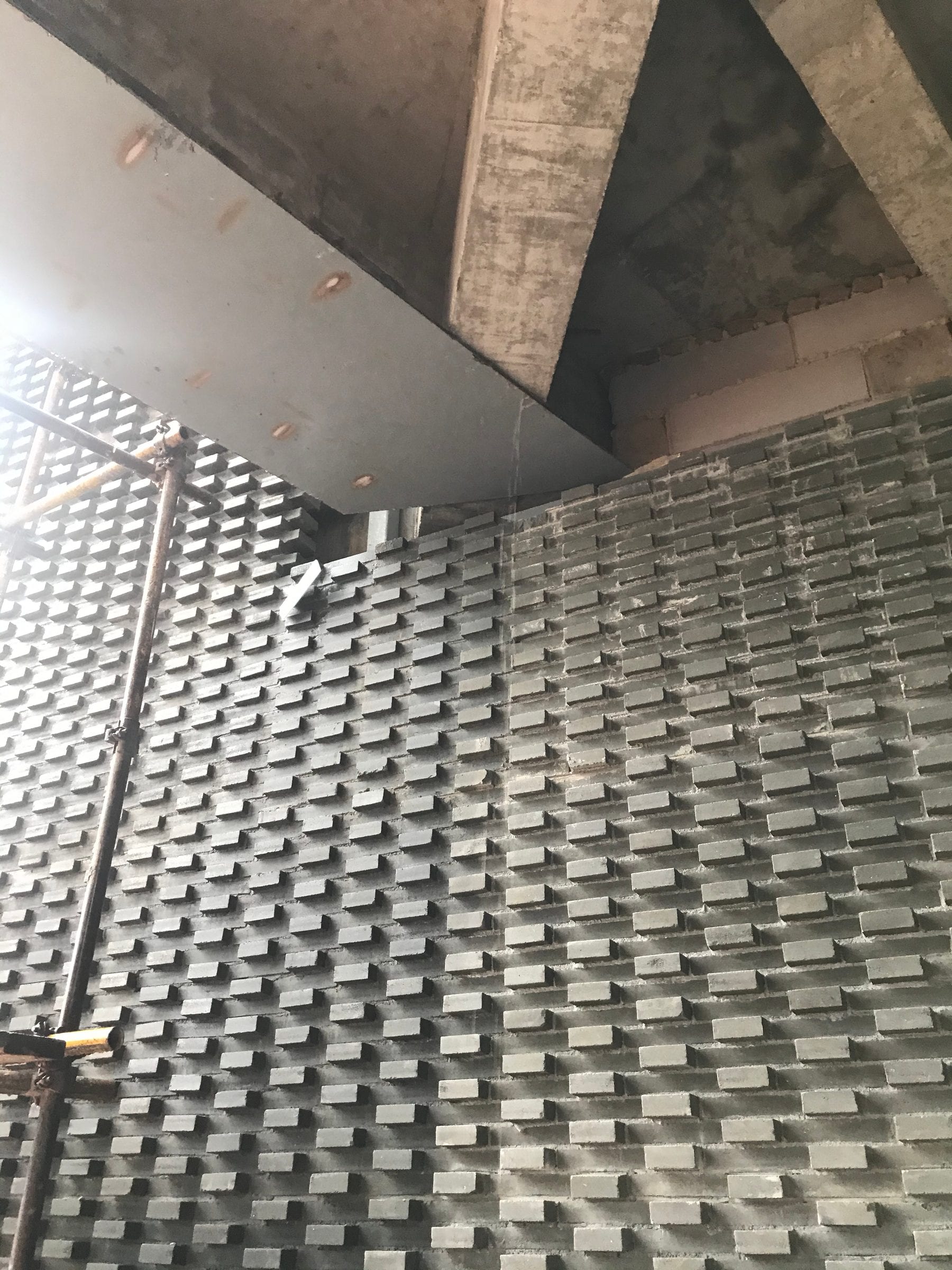 Completed stacked-brick wall wrapping beneath the canopy soffit