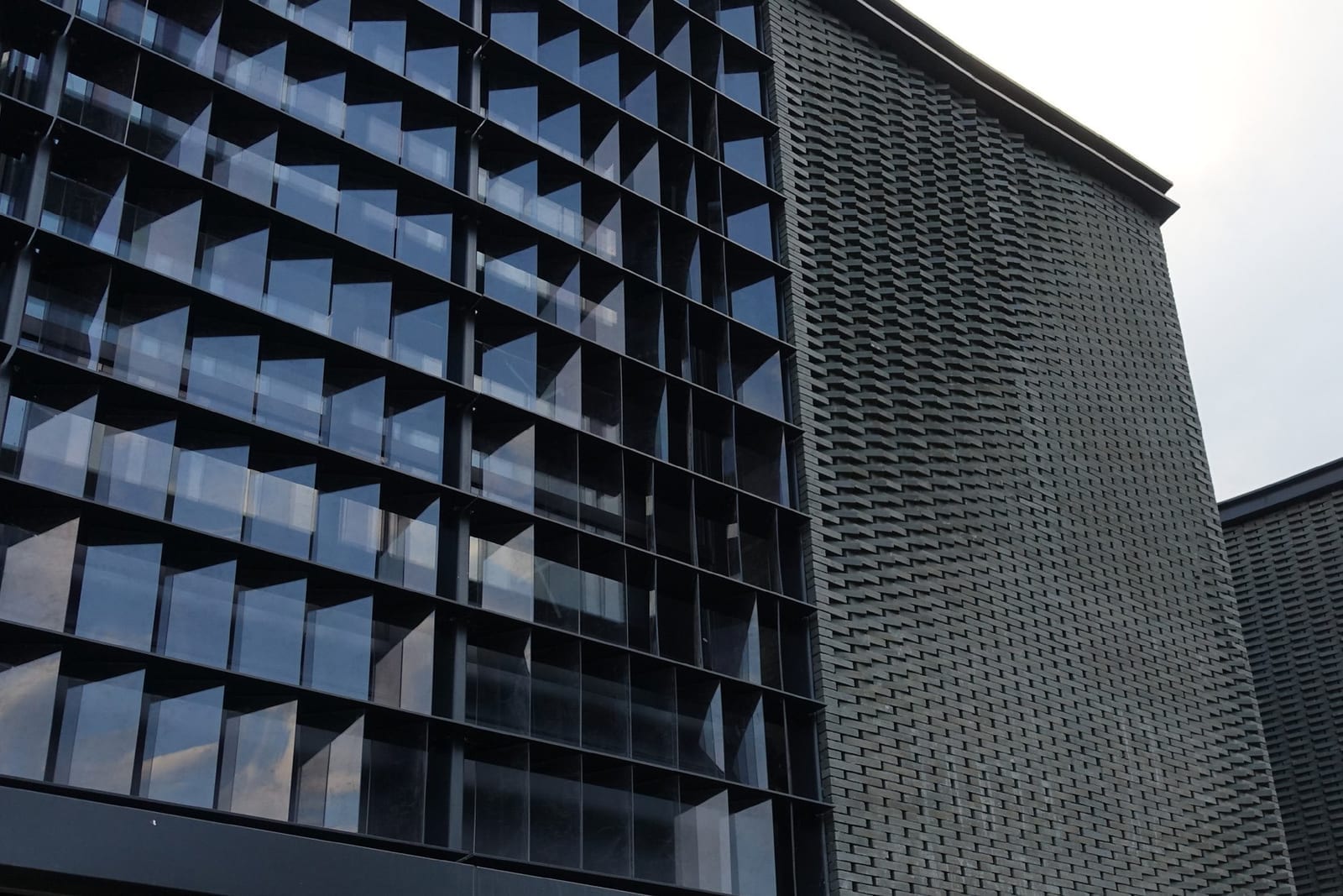 Built facade at Panlong Tiandi with dark brick and glass louvers