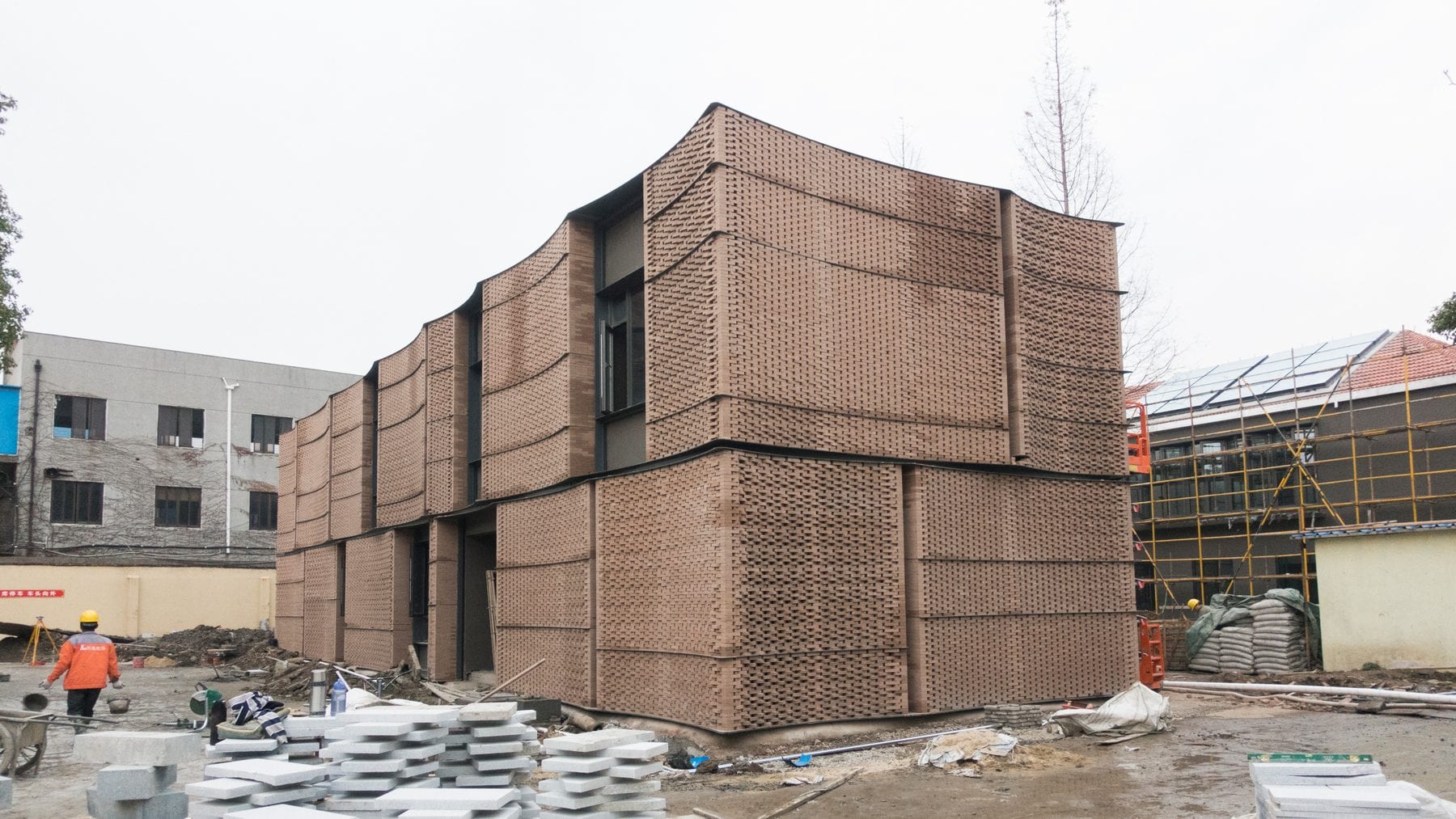 Two-storey woven brick mock-up building used for manual brick infill review