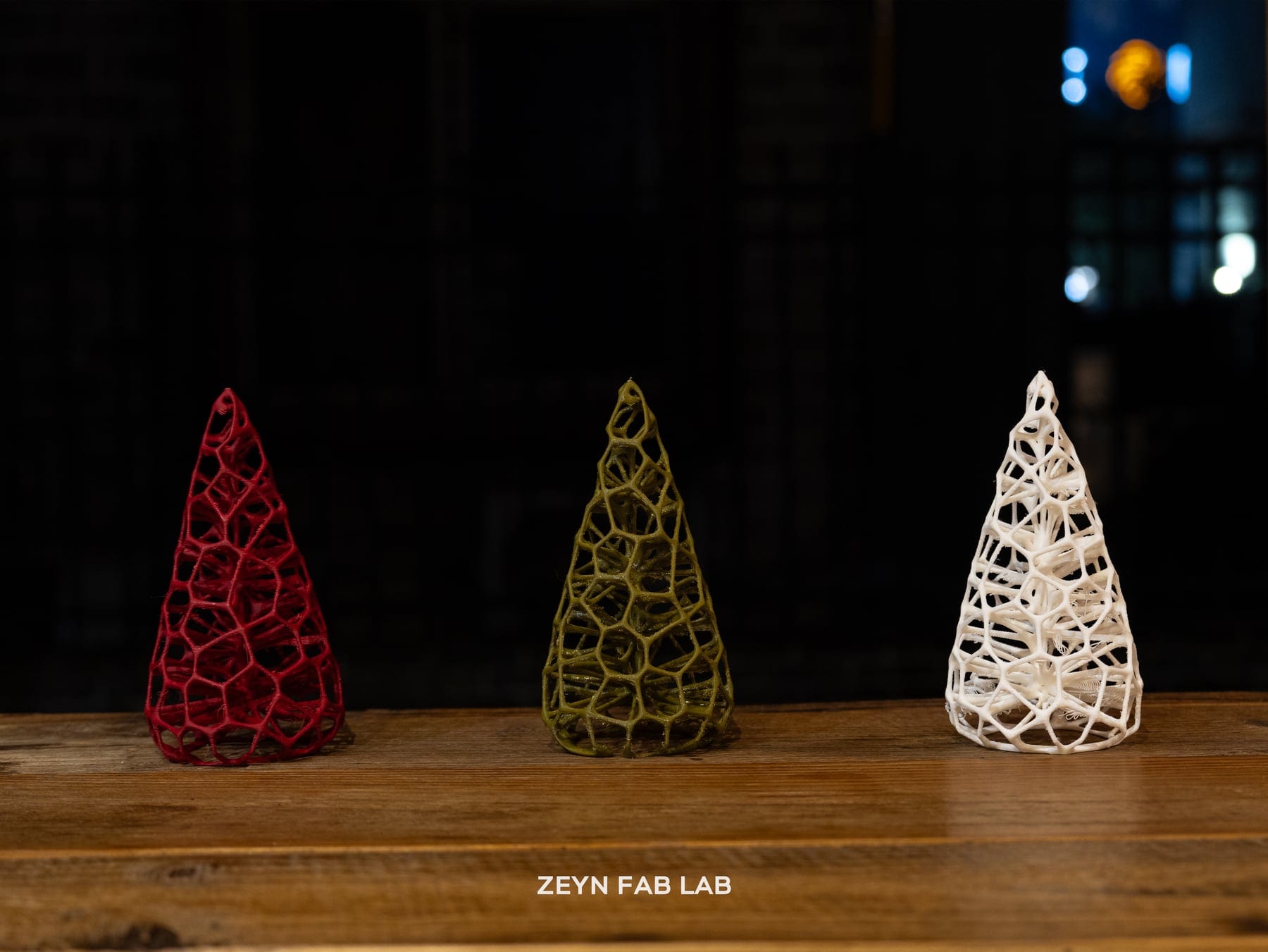 Three Winter Hollow spruce lamps at night