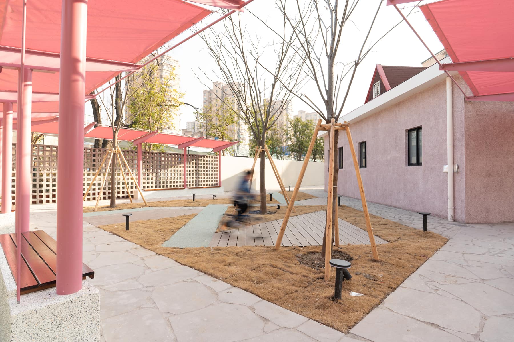 Pergola and screen wall with the residential towers