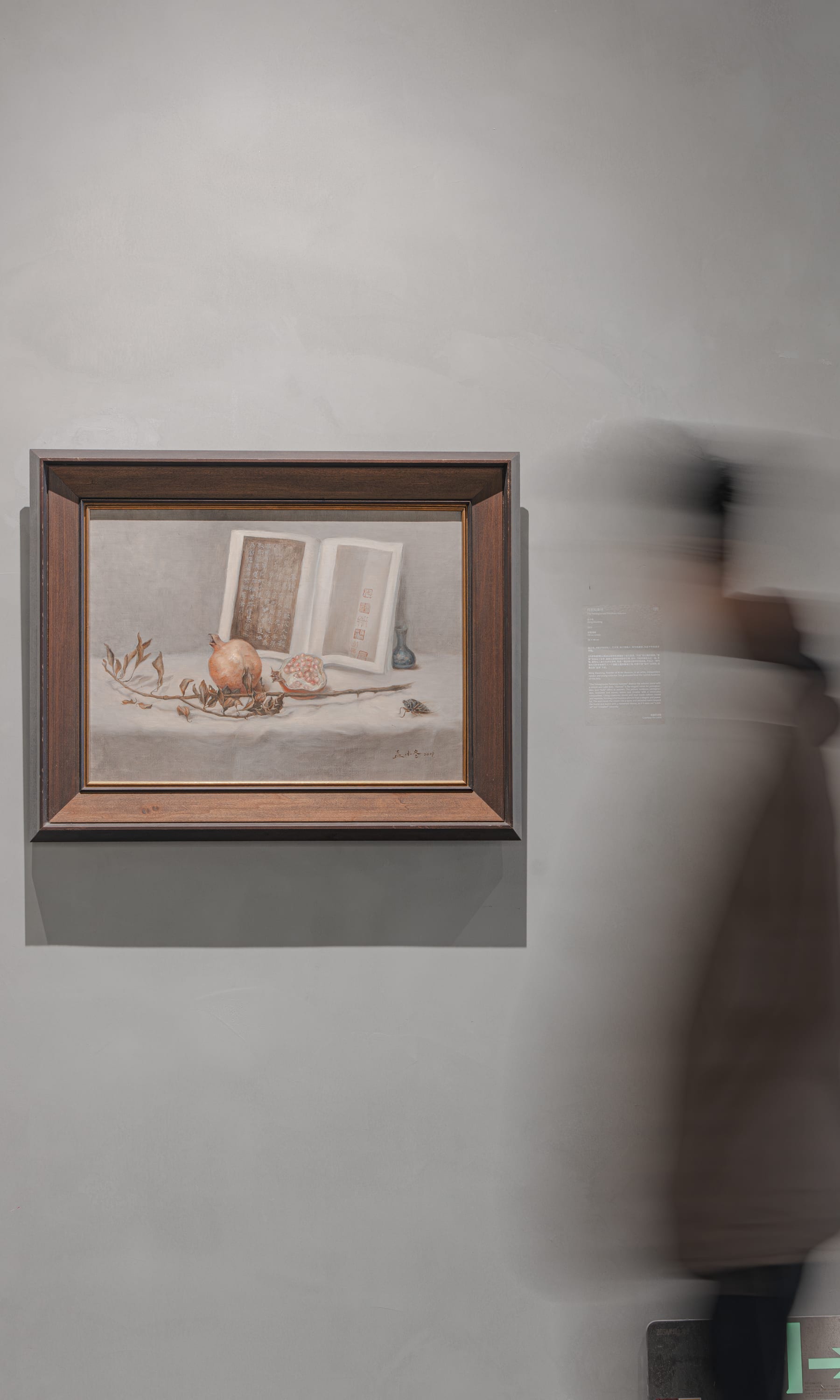 Still-life painting of an open book as a reader drifts past, blurred
