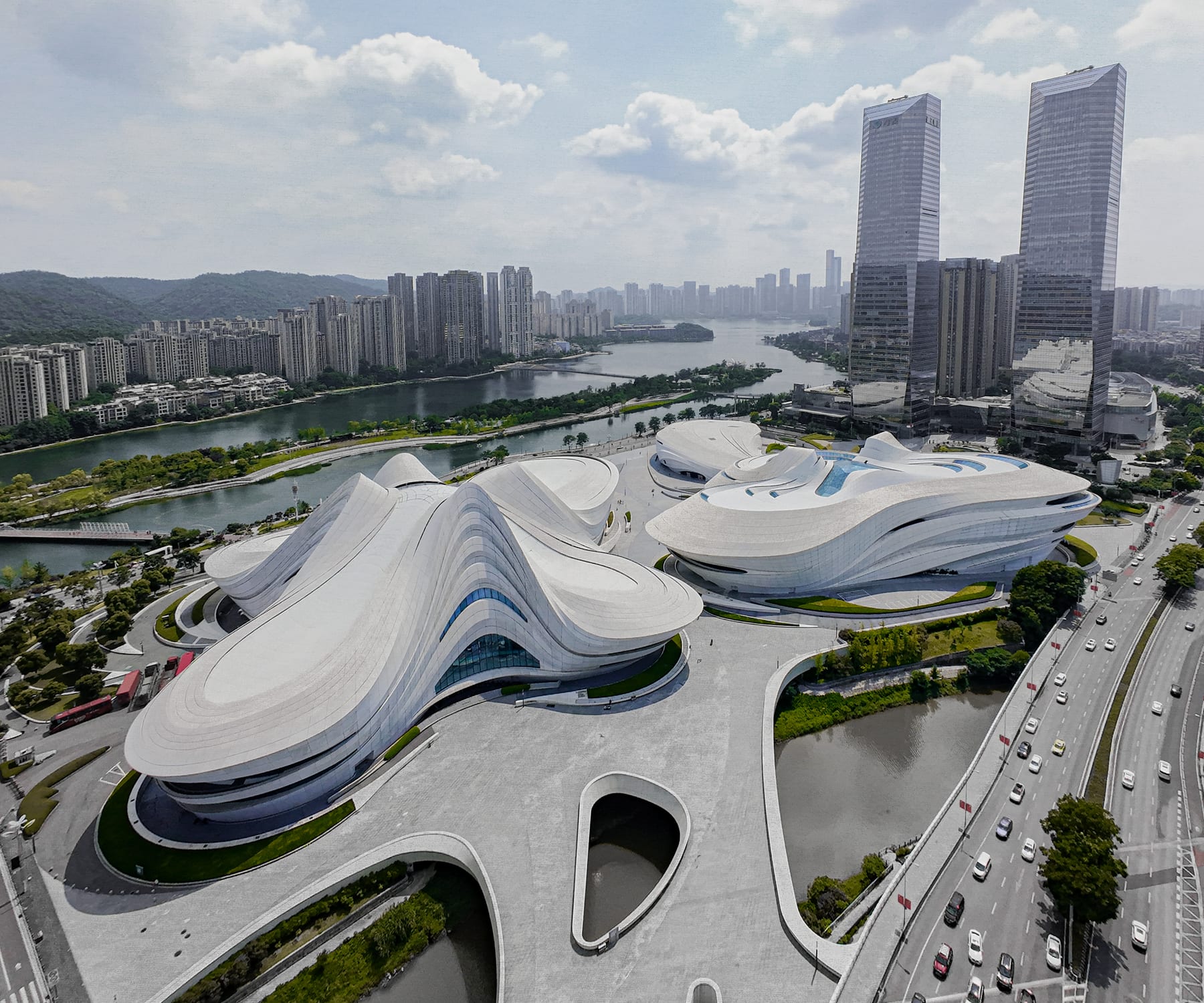 Aerial view of the white petal volumes by Meixi Lake against the city skyline