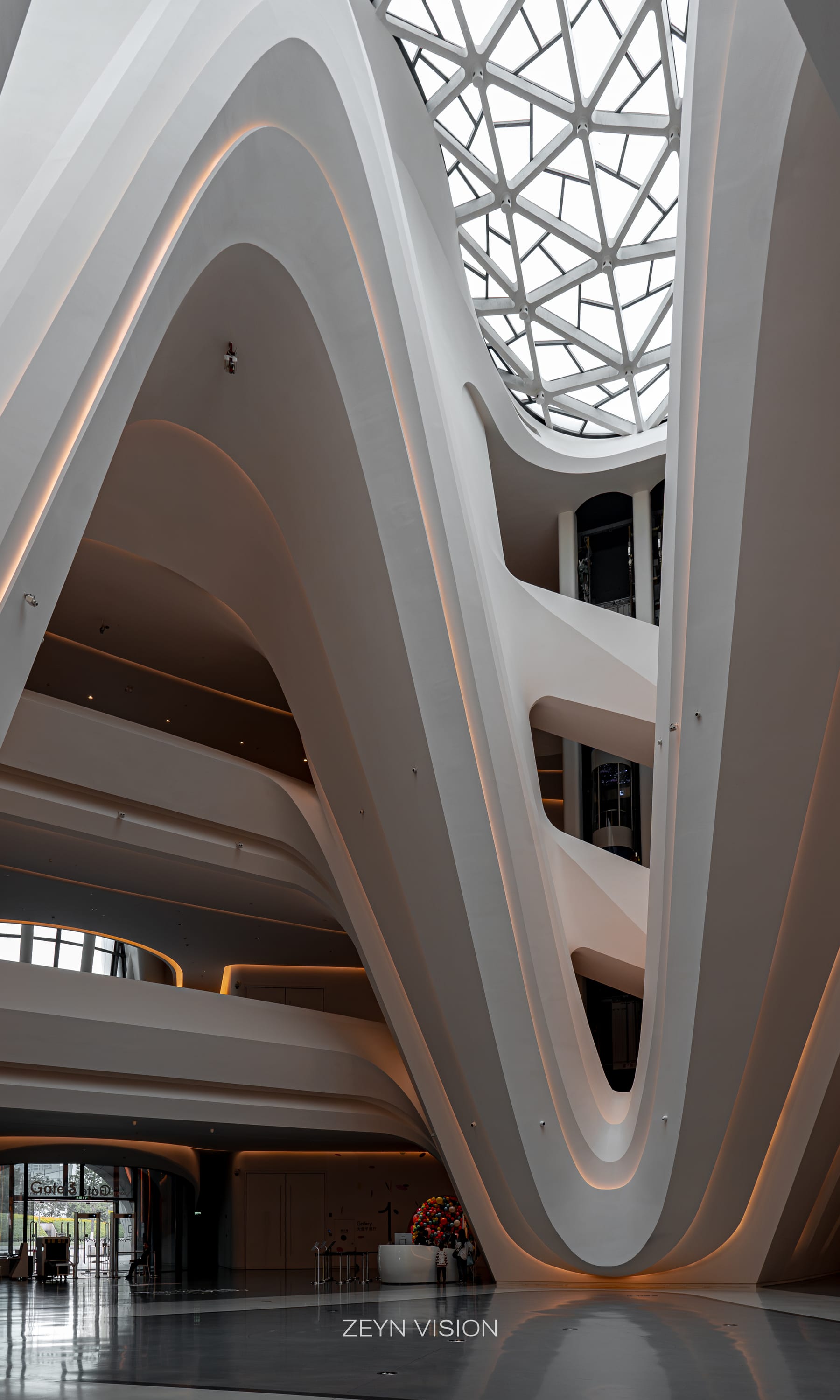 Layered white arches of the atrium, looking up