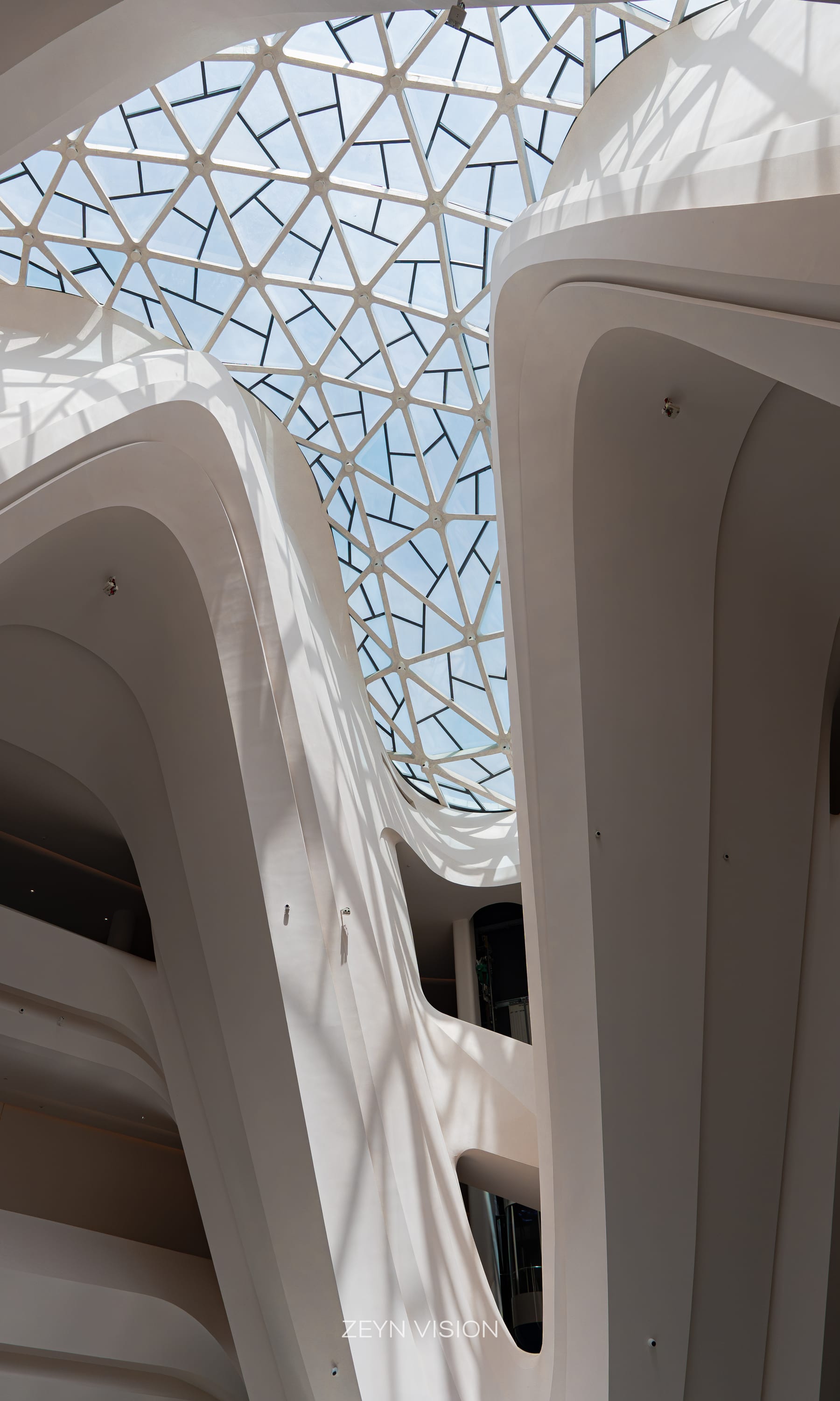 Triangulated skylight grid above the white atrium