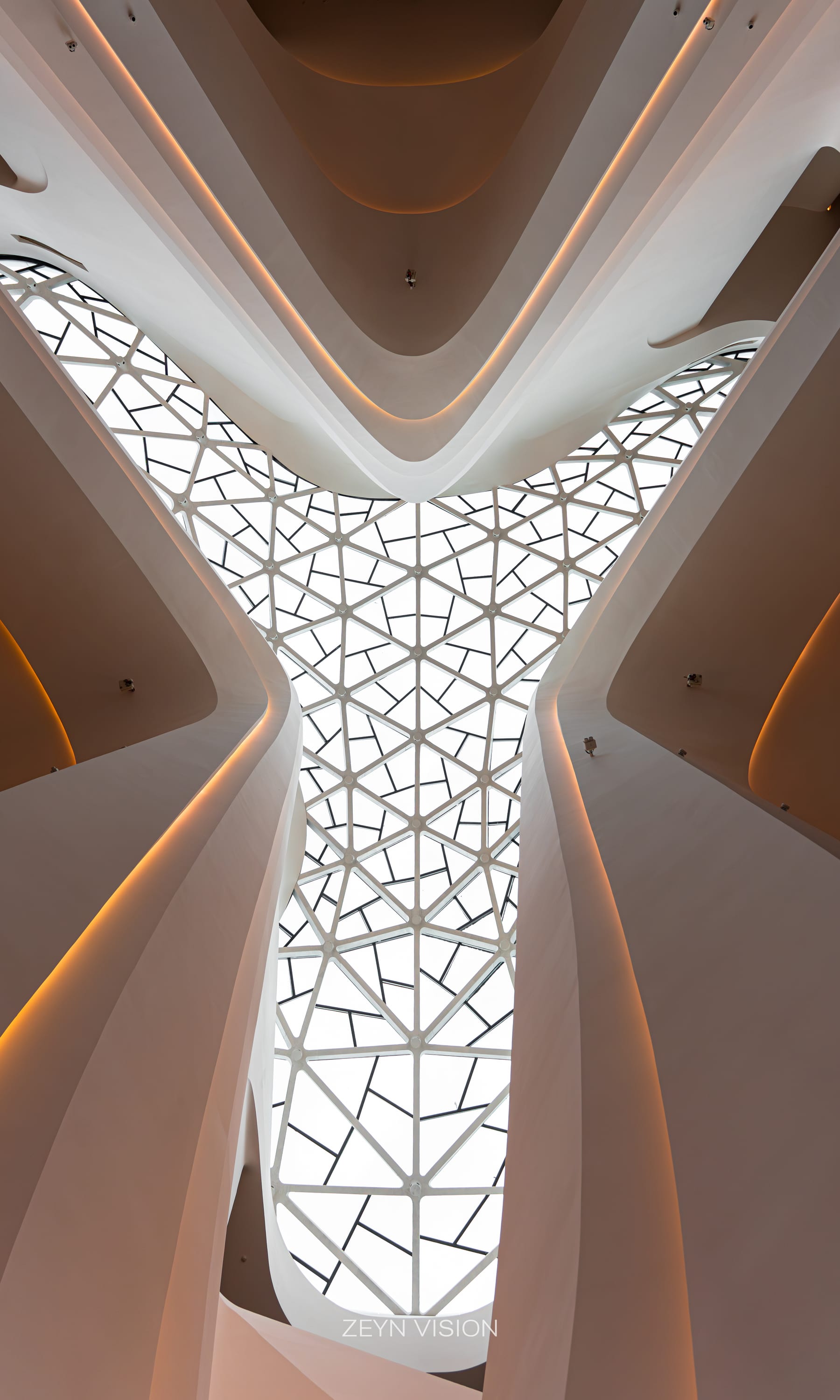 Skylight grid with a warm amber nook folded into the white structure