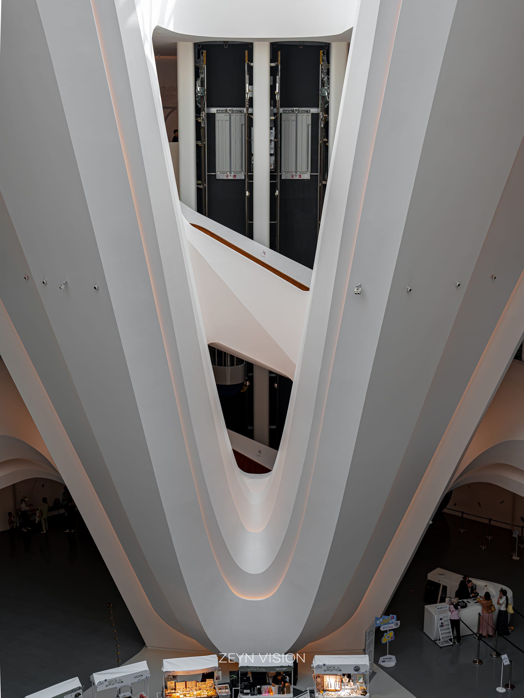 White ribs of the interior gallery framing dark glazing