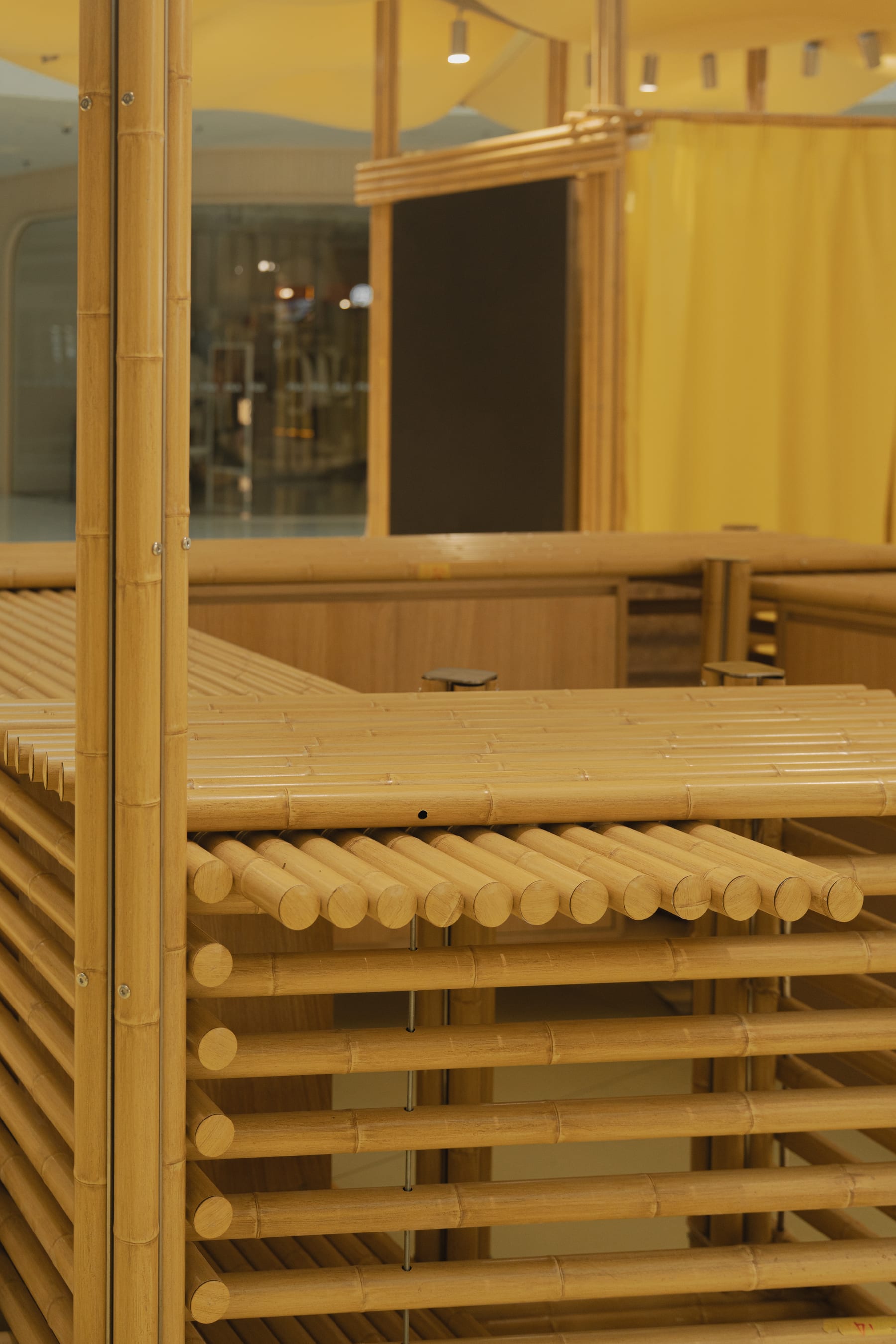 Rod ends of the bamboo screen roof, mall corridor behind