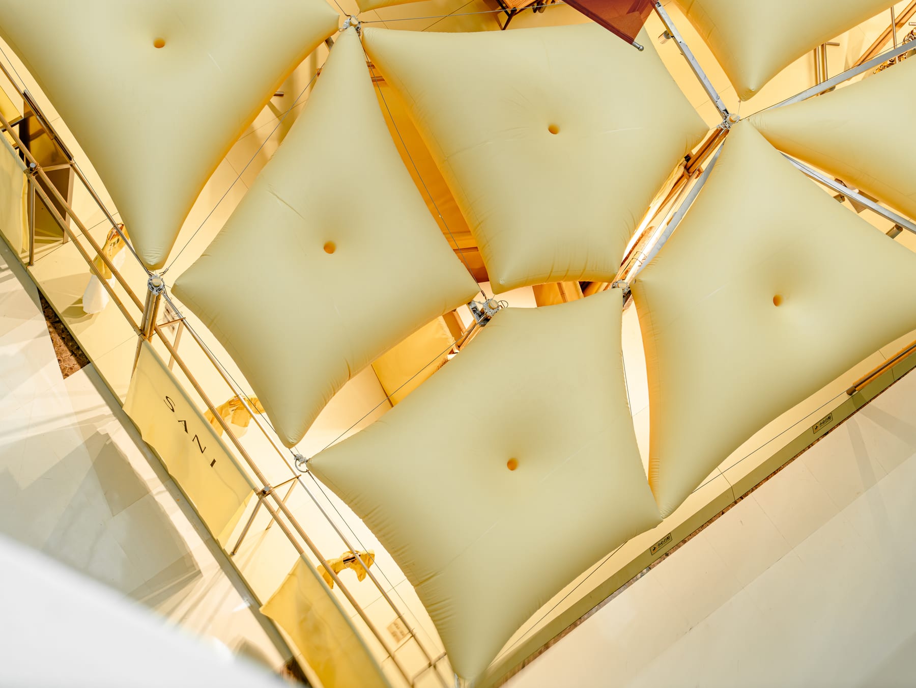 The pillow canopy from above in daylight — pillow grid and steel frame