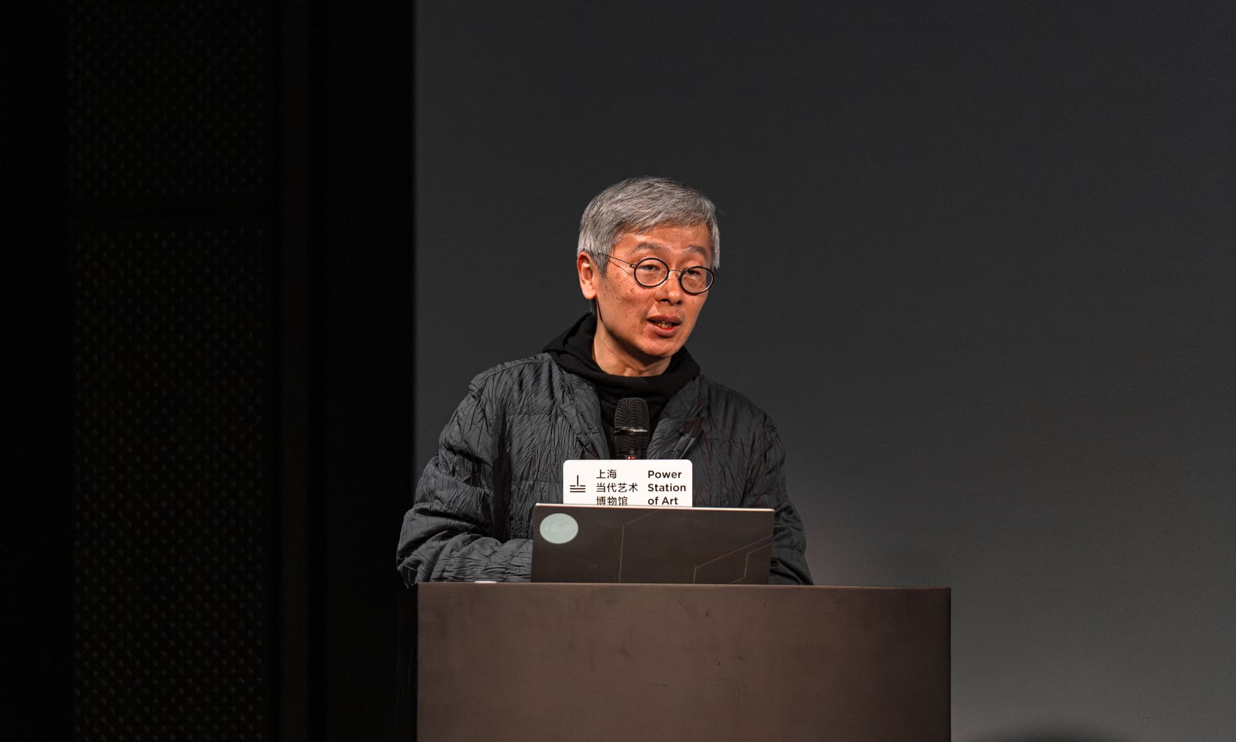 The lecturer with name card, wide