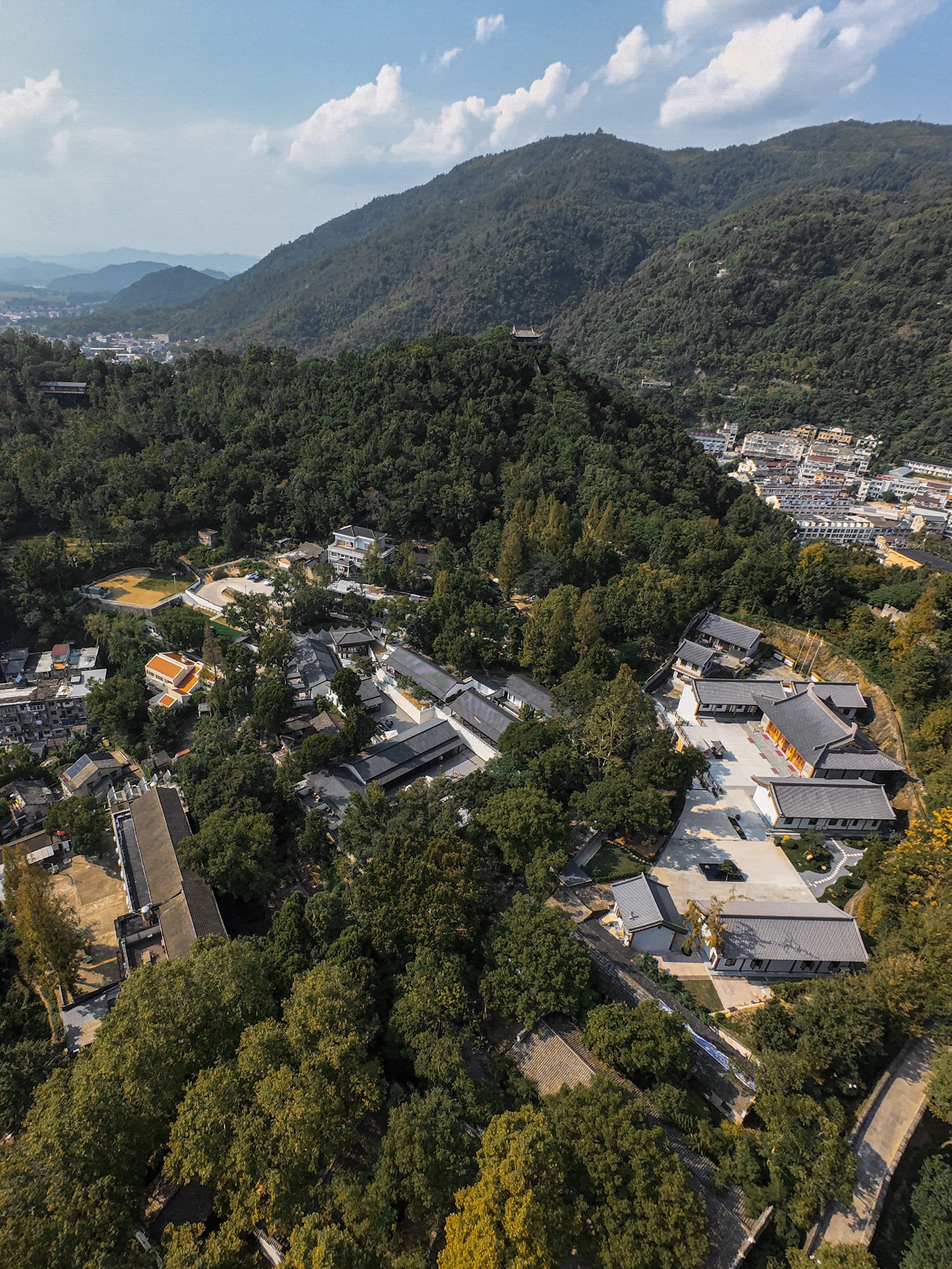 The temple complex nested in forested mountains from above