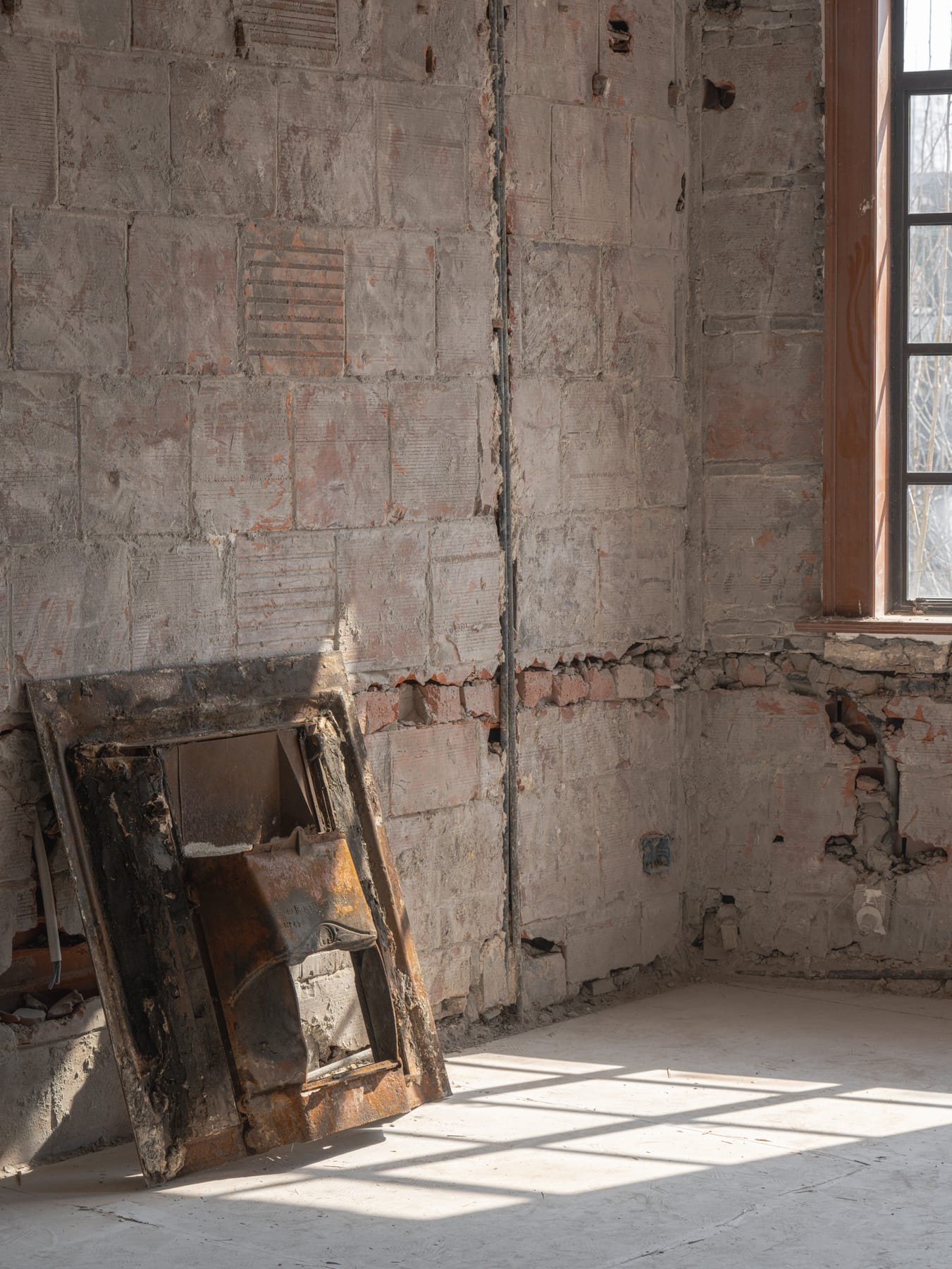 Peeling paint and salvaged window frames in sunlight