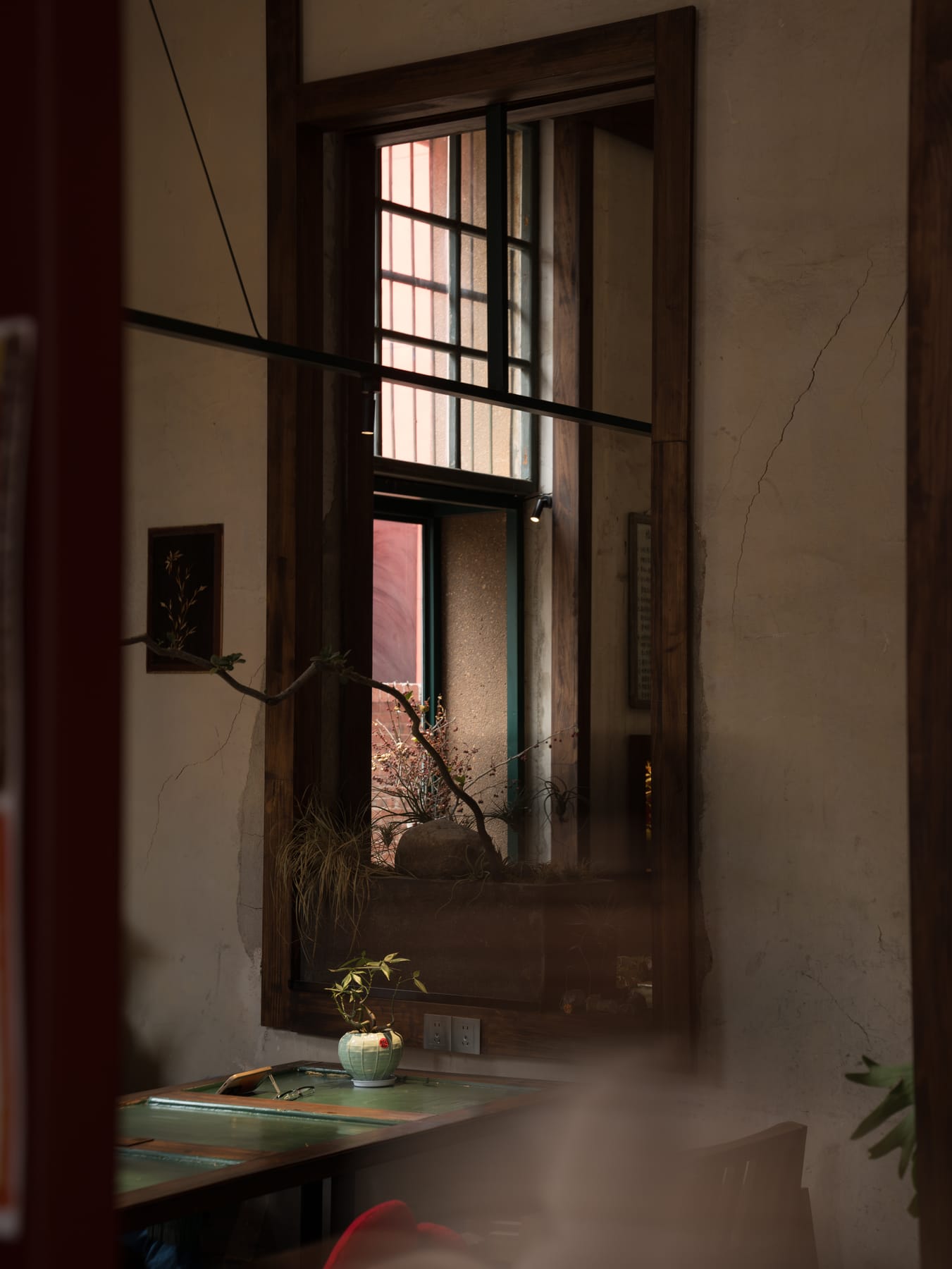 Steam rising by the steel-frame window