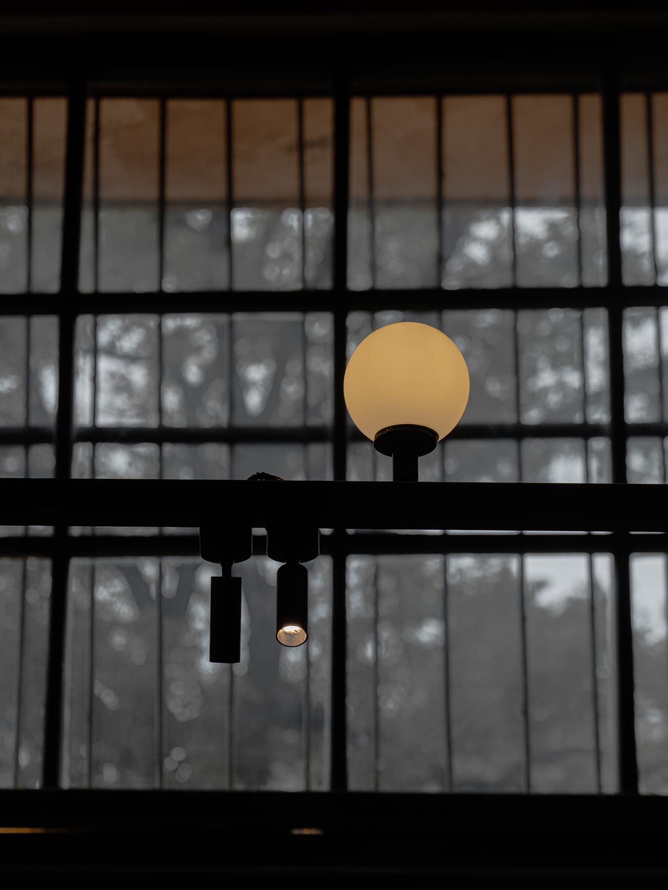 Globe lamps hanging before the window grid